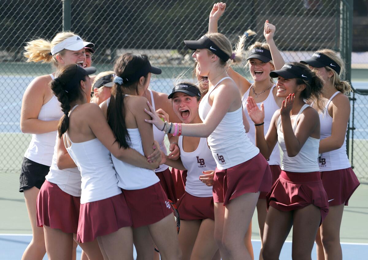 Laguna Beach High School girls' tennis team celebrate after winning the CIF Southern Section Division 2 title on Friday.