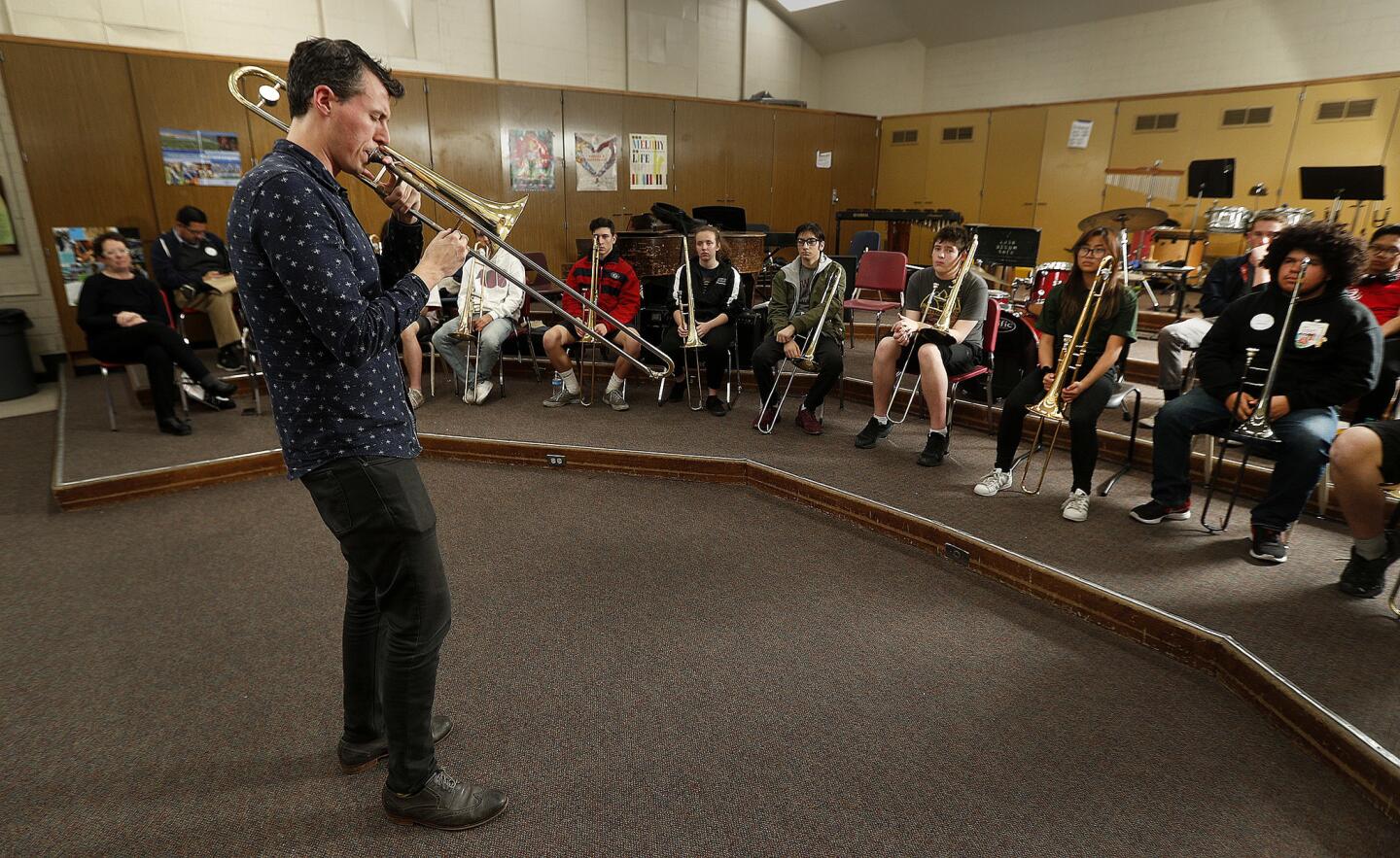 Jazz trombonist Nick Finzer plays his trombone for students in the music room at Glendale High School on Wednesday, March 13, 2019. Finzer, an instructor at the University of North Texas, worked with area trombonists, some which will come from GUS and local colleges, about some trombone techniques for warm up, and discovering jazz. Finzer is squeezing in his clinic amidst a national tour. Later that same evening, he will be performing at the Blue Whale Bar in Los Angeles.
