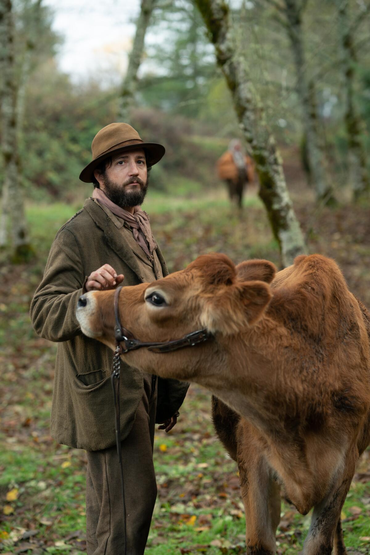 This image released by A24 shows John Magaro in a scene from the film "First Cow." The New York Film Critics Circle on Friday, Dec. 18, 2020, voted Kelly Reichardt’s Western fable “First Cow” the best film of 2020. (Allyson Riggs/A24 via AP)