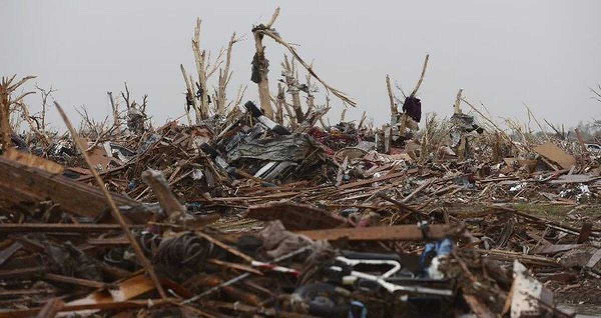 The rubble of homes in a destroyed neighborhood in Moore, Okla., on Tuesday. The town was hit by a tornado Monday, killing at least 24 people, many of them schoolchildren.