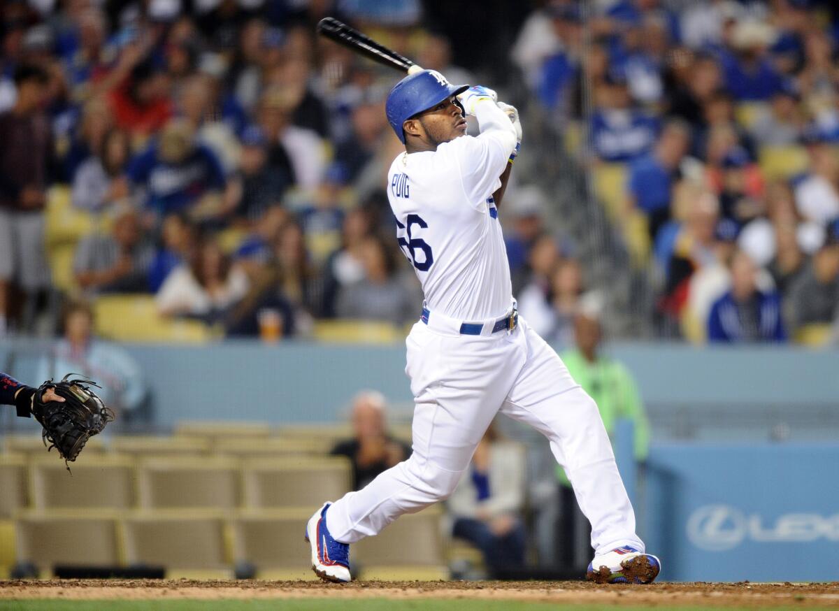 Yasiel Puig hits a solo home run against the Cardinals during the eighth inning of a game on May 13 at Dodger Stadium.