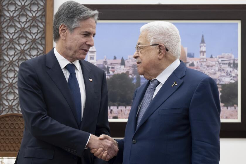 Palestinian Authority President Mahmud Abbas, right, and US Secretary of State Antony Blinken shake hands prior to a meeting at the Muqata, the presidential compound in the West Bank city of Ramallah, Thursday Nov. 30, 2023. (Saul Loeb/Pool Photo via AP)