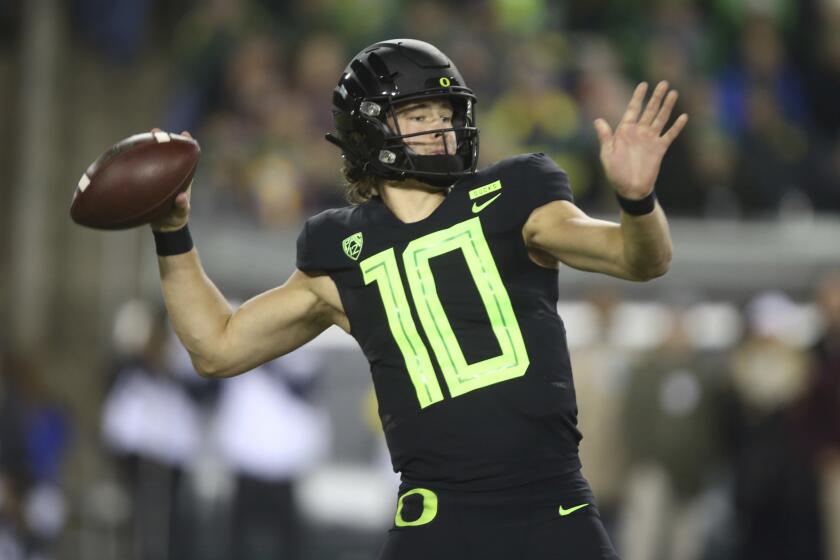 File-This Nov. 17, 2018, file photo shows Oregon quarterback Justin Herbert throwing down field against Arizona State during the first quarter of an NCAA college football game in Eugene, Ore. Herbert says hell return for his senior season. Herbert announced his decision on Wednesday, Dec. 26, 2018, before the Oregon left Eugene for the Redbox Bowl. Oregon plays Michigan State on Monday. (AP Photo/Chris Pietsch, File)