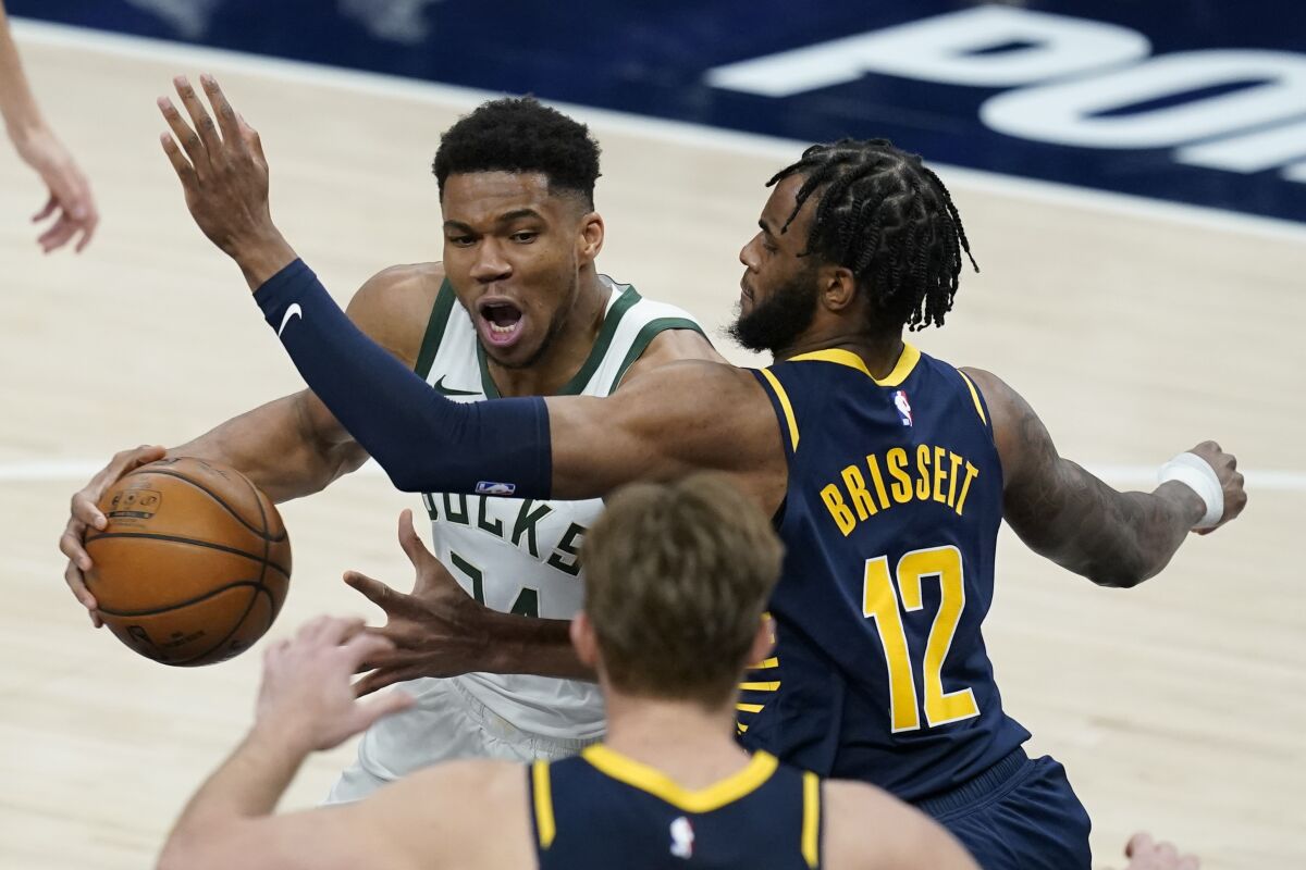 Milwaukee Bucks' Giannis Antetokounmpo (34) goes to the basket against Indiana Pacers' Oshae Brissett (12) during the second half of an NBA basketball game Thursday, May 13, 2021, in Indianapolis. (AP Photo/Darron Cummings)