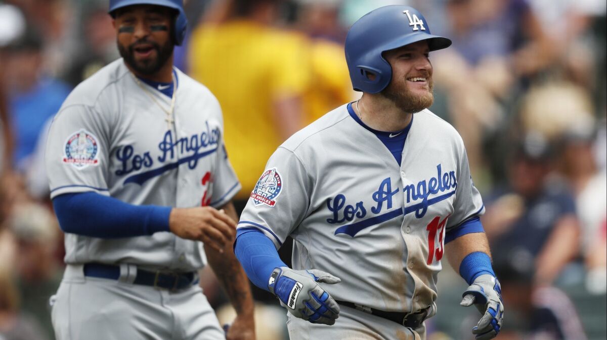 Max Muncy, right, smiles as he heads back to the dugout with Matt Kemp after homering in a game last month.