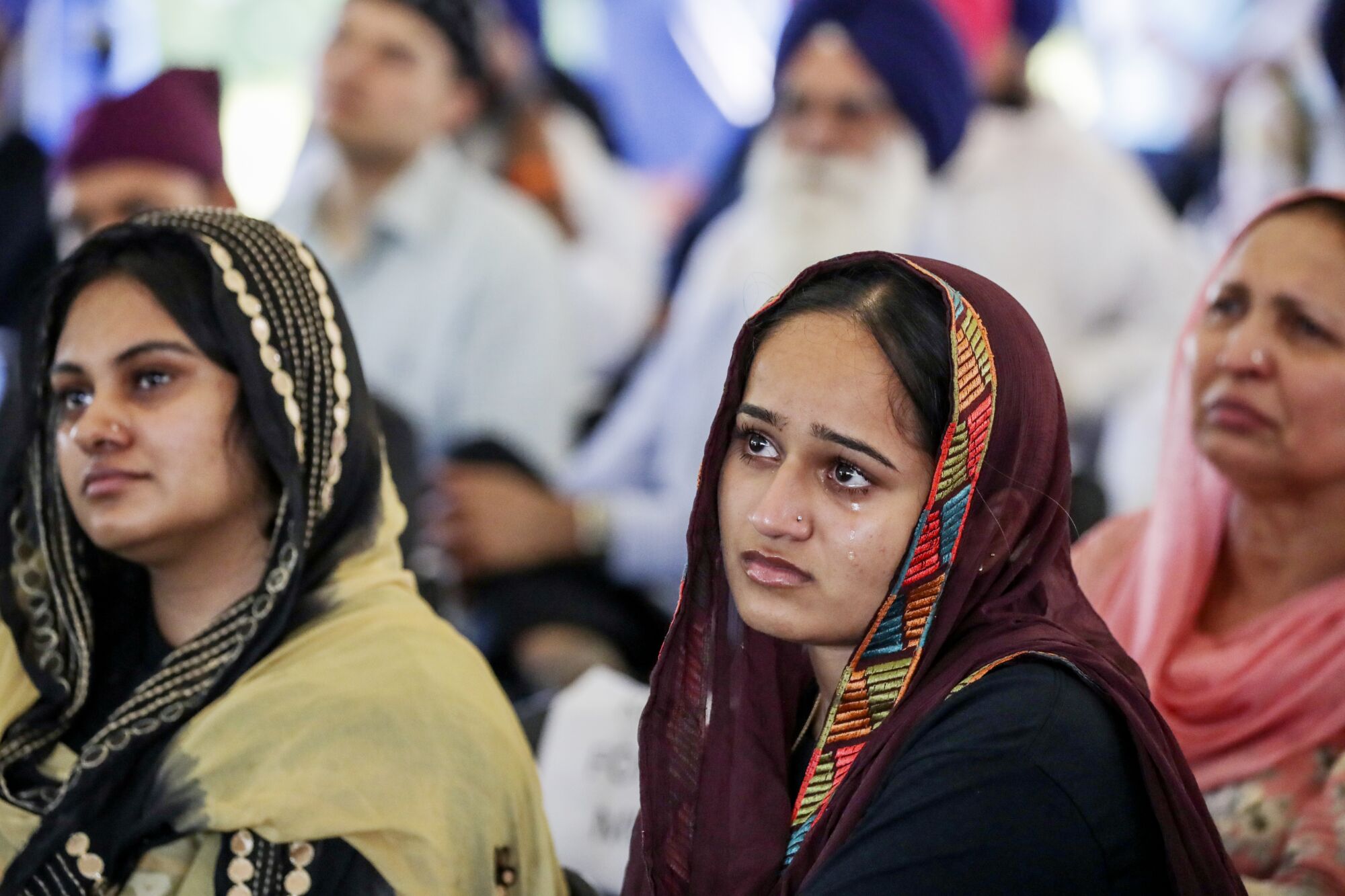 Tears stream down the face of Palmeet Kaur at   Sikh Temple of Wisconsin.