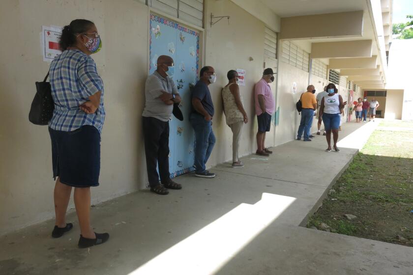 Voters wait to cast their ballots in Loíza, Puerto Rico, Sunday, Aug. 16, 2020. Thousands of Puerto Ricans on Sunday got a second chance to vote for the first time, a week after delayed and missing ballots marred the original primaries in a blow to the U.S. territory’s democracy. (AP Photo/Dánica Coto)