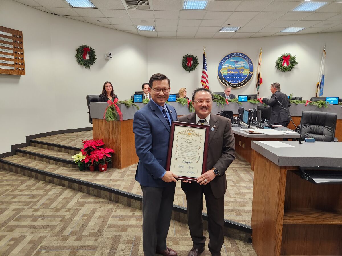Orange County Supervisor Andrew Do, left, presents a plaque to Fountain Valley City Councilman Michael Vo.