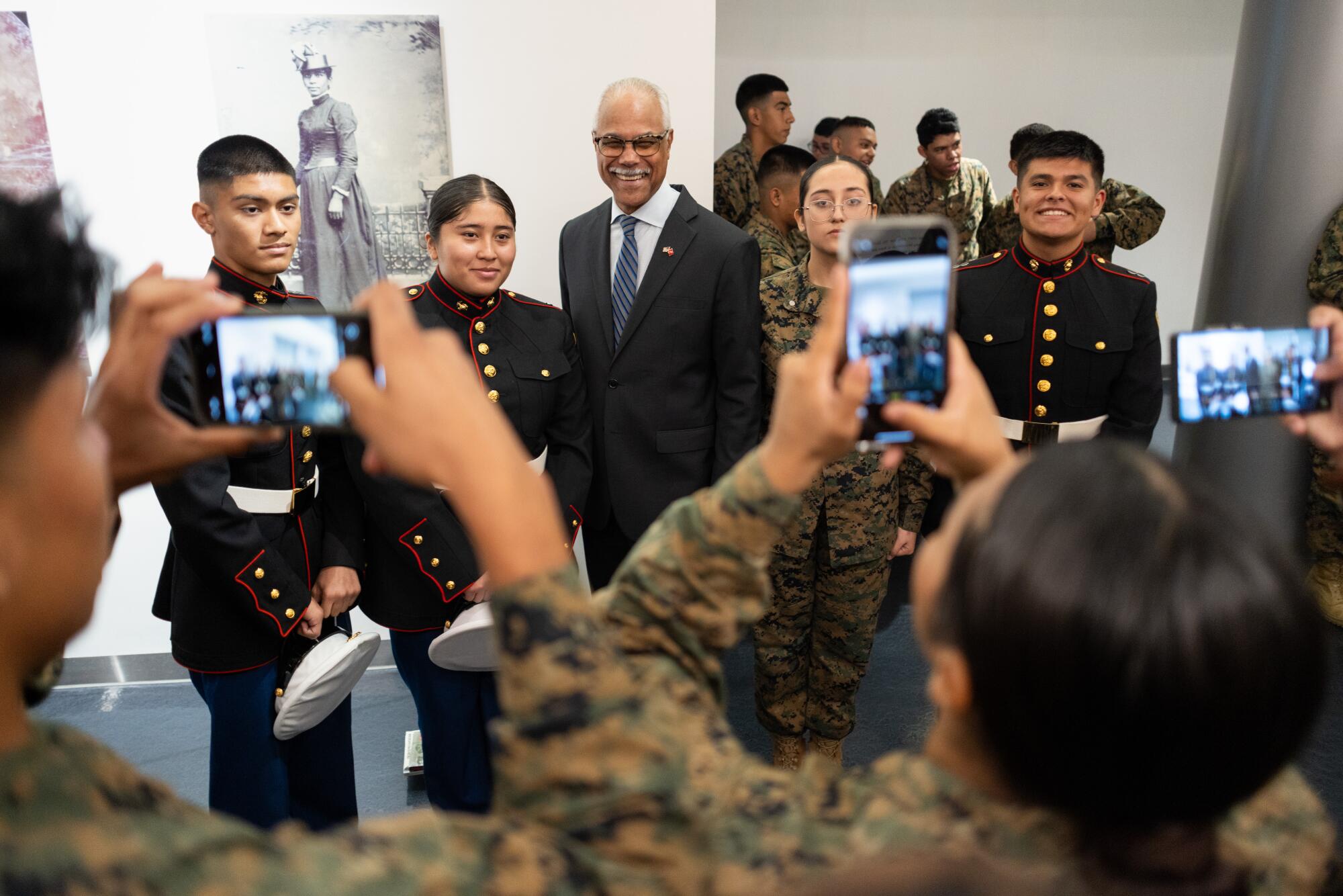 Maj. Gen. Leo V. Williams III takes pictures with John C. Fremont High School Marine Corps JROTC students.