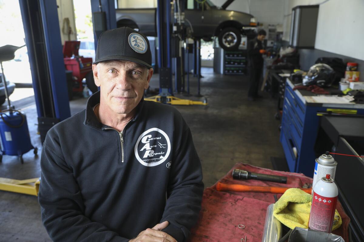 Kevin Schugar, who is a mechanic and co-owner of Coastal Auto Repair in Pacific Beach, poses for photos in the garage on April 14, 2020 in San Diego, California.