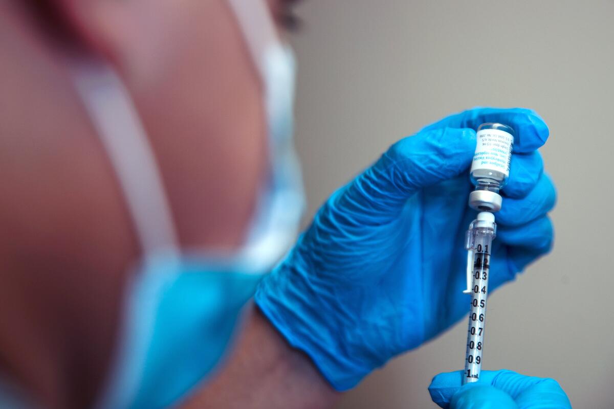 A registered nurse prepares a monkeypox virus vaccine