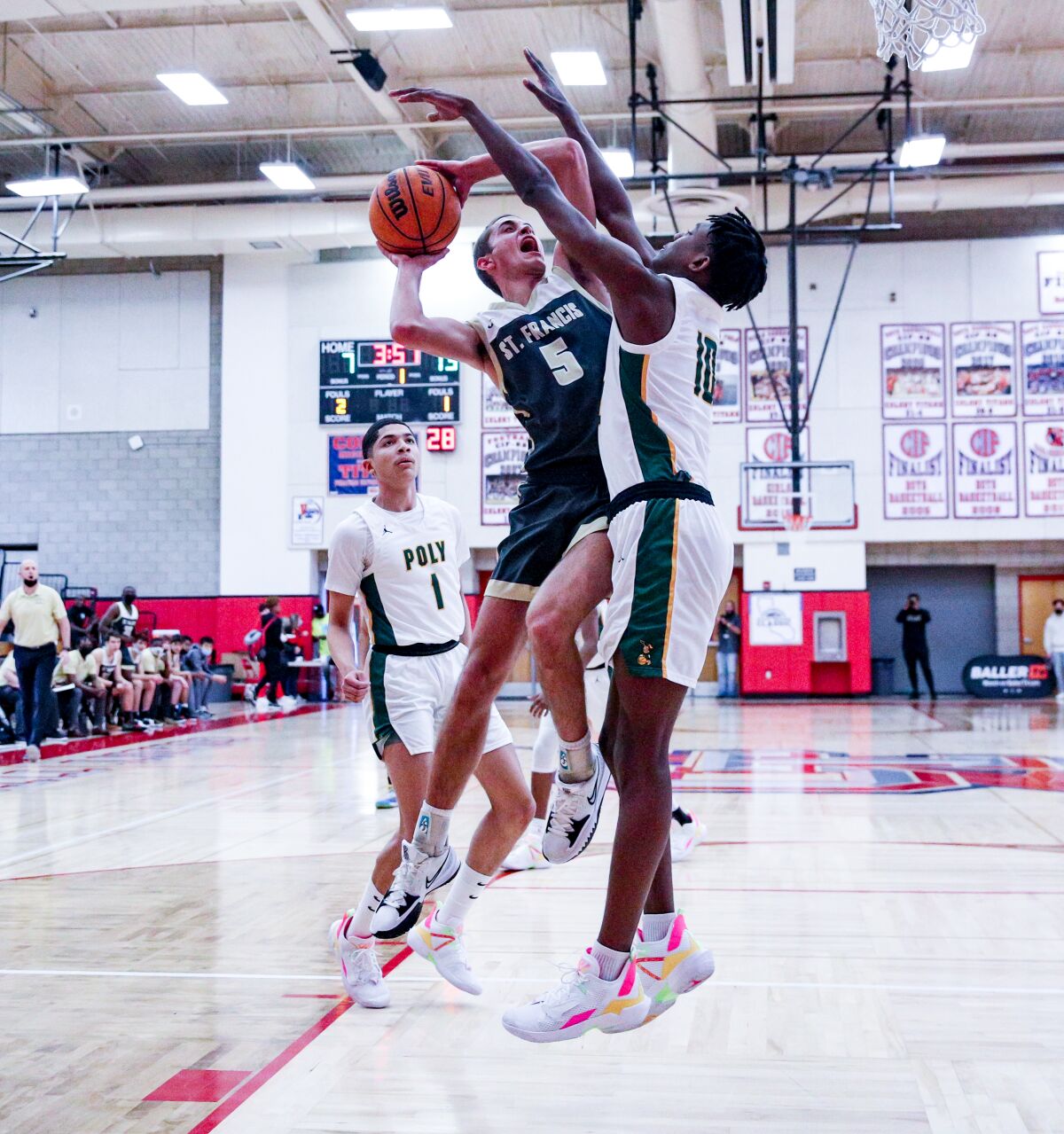 Buckley DeJardin of St. Francis tries to get the ball up against Long Beach Poly's Daniel Hardy at Colony.