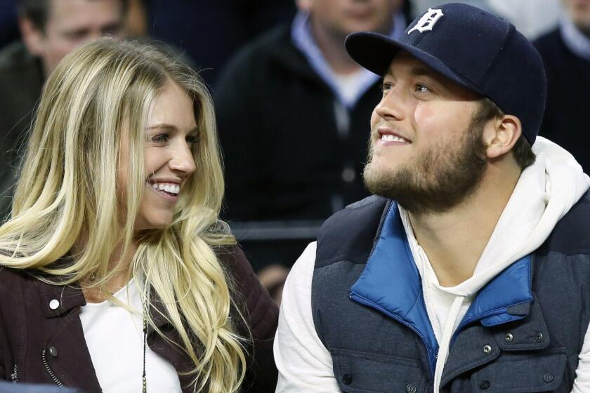 FILE - In this Nov. 17, 2015, file photo, Detroit Lions quarterback Matthew Stafford, right, smiles while watching the Detroit Pistons play the Cleveland Cavaliers with his wife Kelly, left, during the first half of an NBA basketball game, in Auburn Hills, Mich. Kelly Stafford plans to have surgery to remove a brain tumor. Stafford shared the details Wednesday, April 3, 2019, on her Instagram account. She says an MRI showed the tumor on cranial nerves after she had vertigo spells within the last year. (AP Photo/Duane Burleson, File)