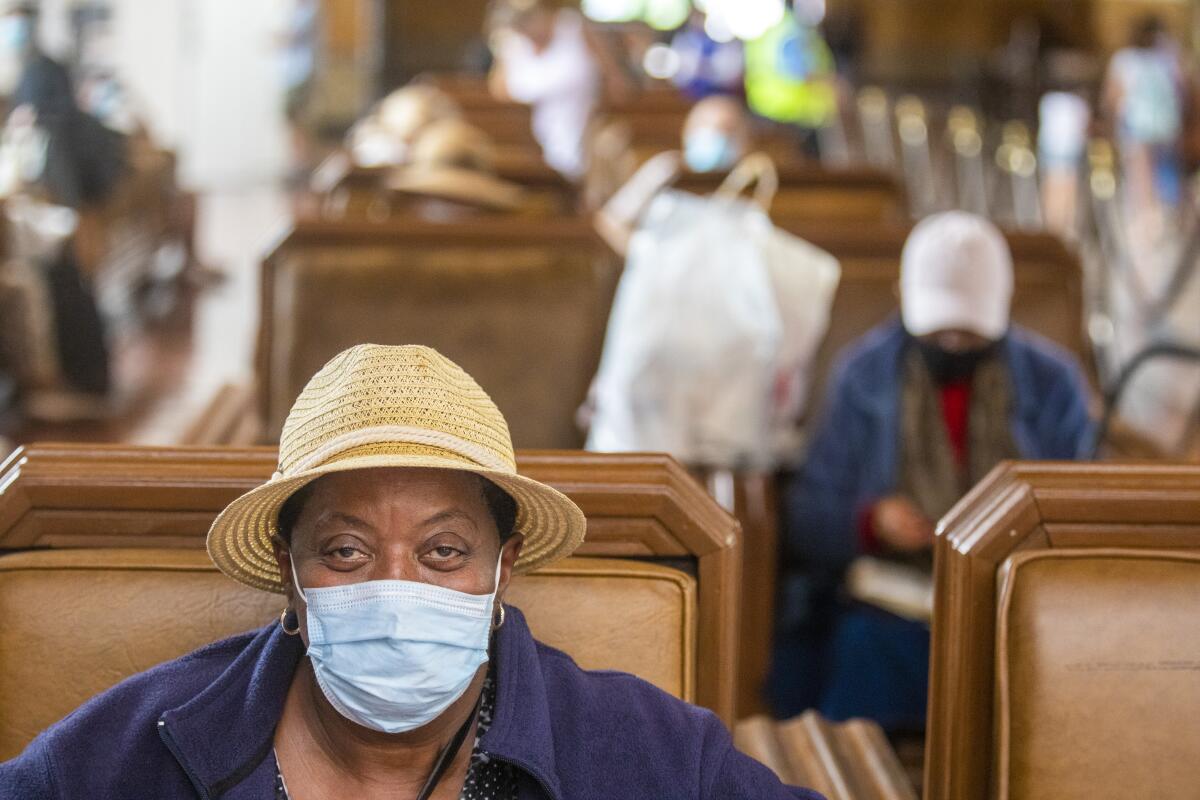 A rail passenger sits inside Los Angeles Union Station wearing a face mask on June 29. 