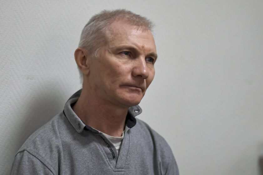 Alexei Moskalyov sits in a courtroom in Yefremov, Tula region, some 300 kilometers (186 miles) south of Moscow, Russia, Monday, March 27, 2023. A court in Russia on Tuesday convicted a single father over social media posts criticizing the war in Ukraine and sentenced him to two years in prison — a case brought to the attention of authorities by his daughter's drawings against the invasion at school, according to the man's lawyer and local activists. The 54-year-old Moskalyov, a single father of a 13-year-old daughter, was accused of repeatedly discrediting the Russian army, a criminal offense in accordance to a law Russian authorities adopted shortly after sending troops into Ukraine. (AP Photo)