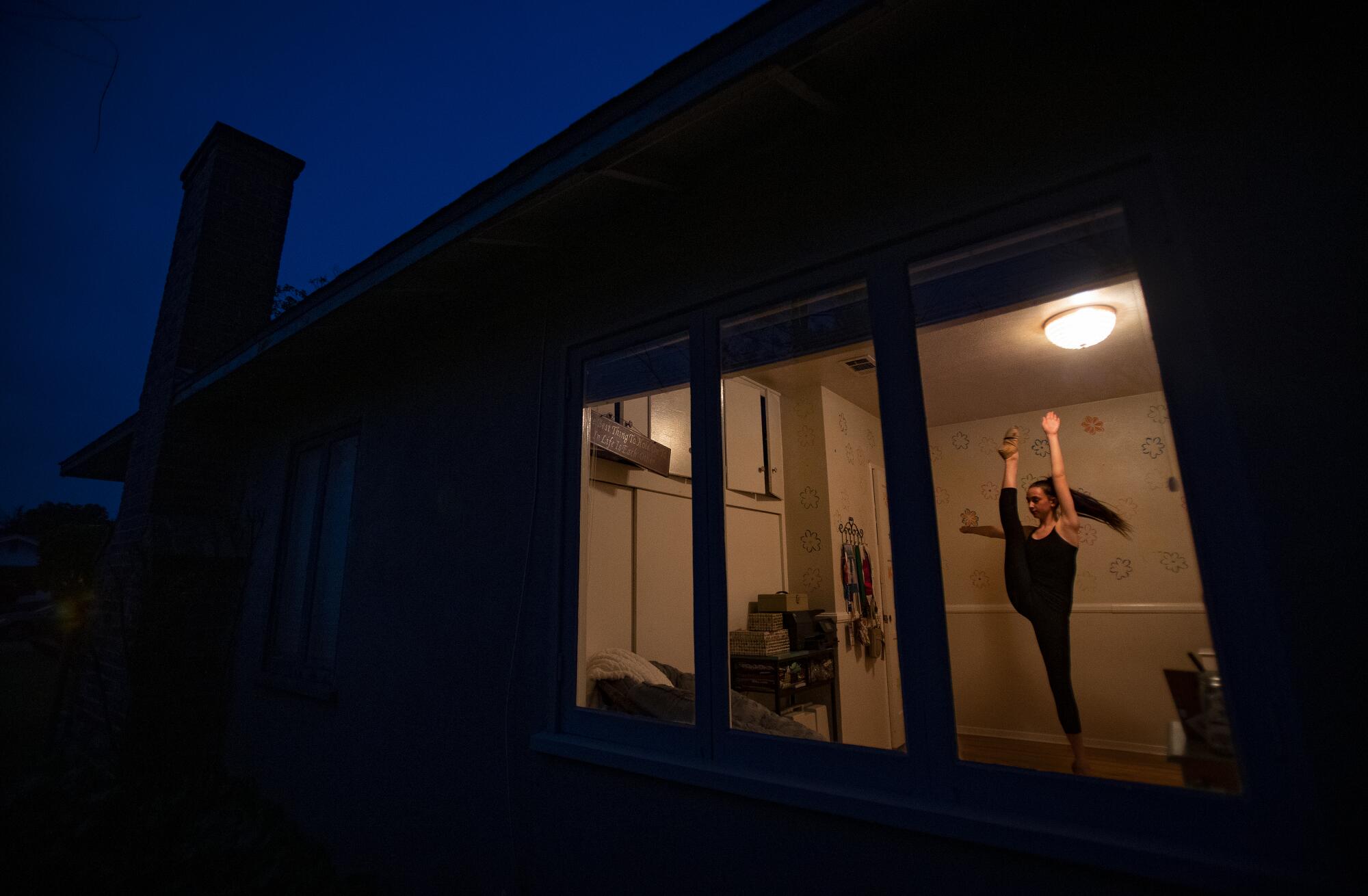 Grace Carter, 15, practices her dance routine in her bedroom in Riverside. 