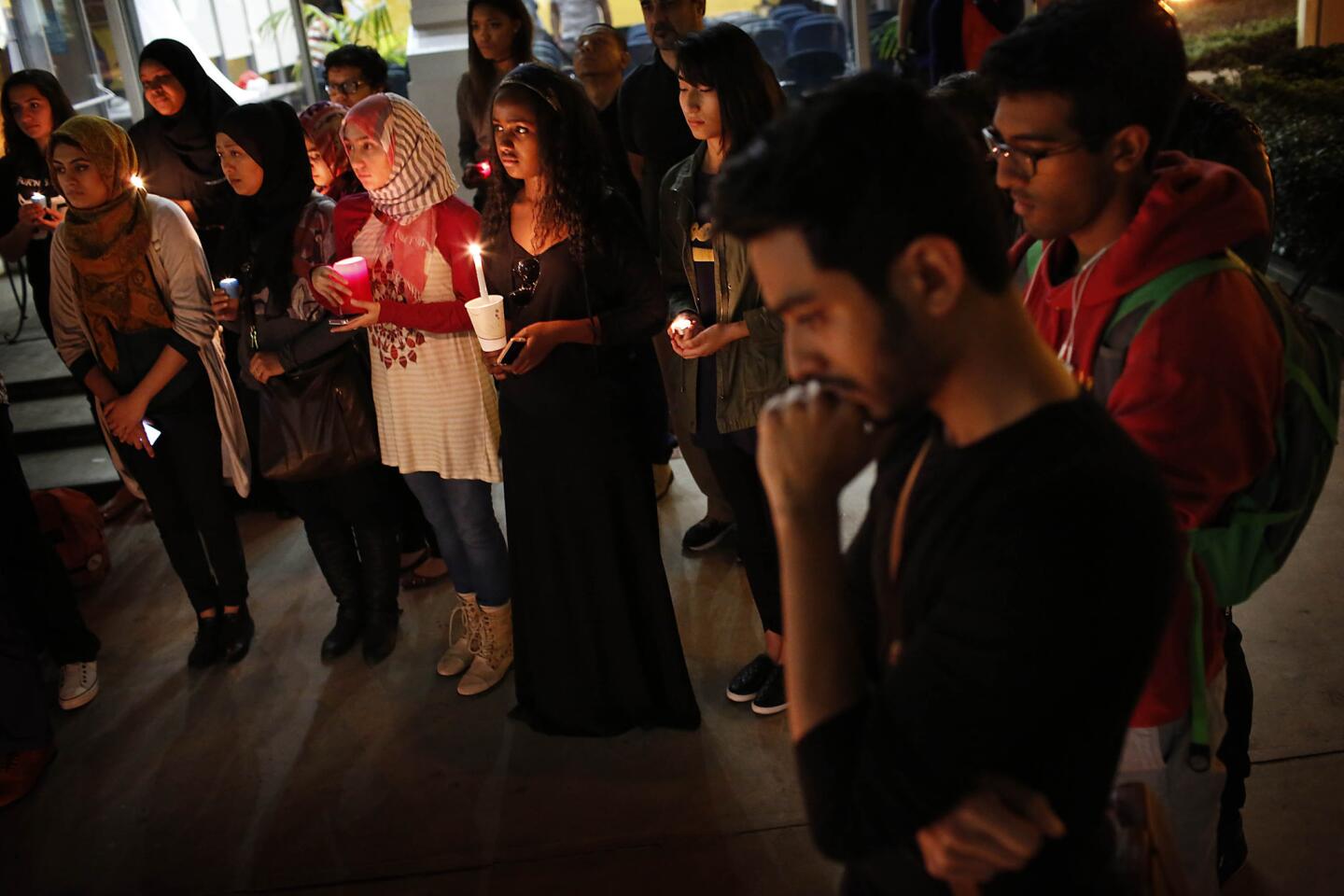Vigil co-organizer Hishaam Siddiqi, foreground, mourns the three Muslim students killed in a residential complex at the University of North Carolina.