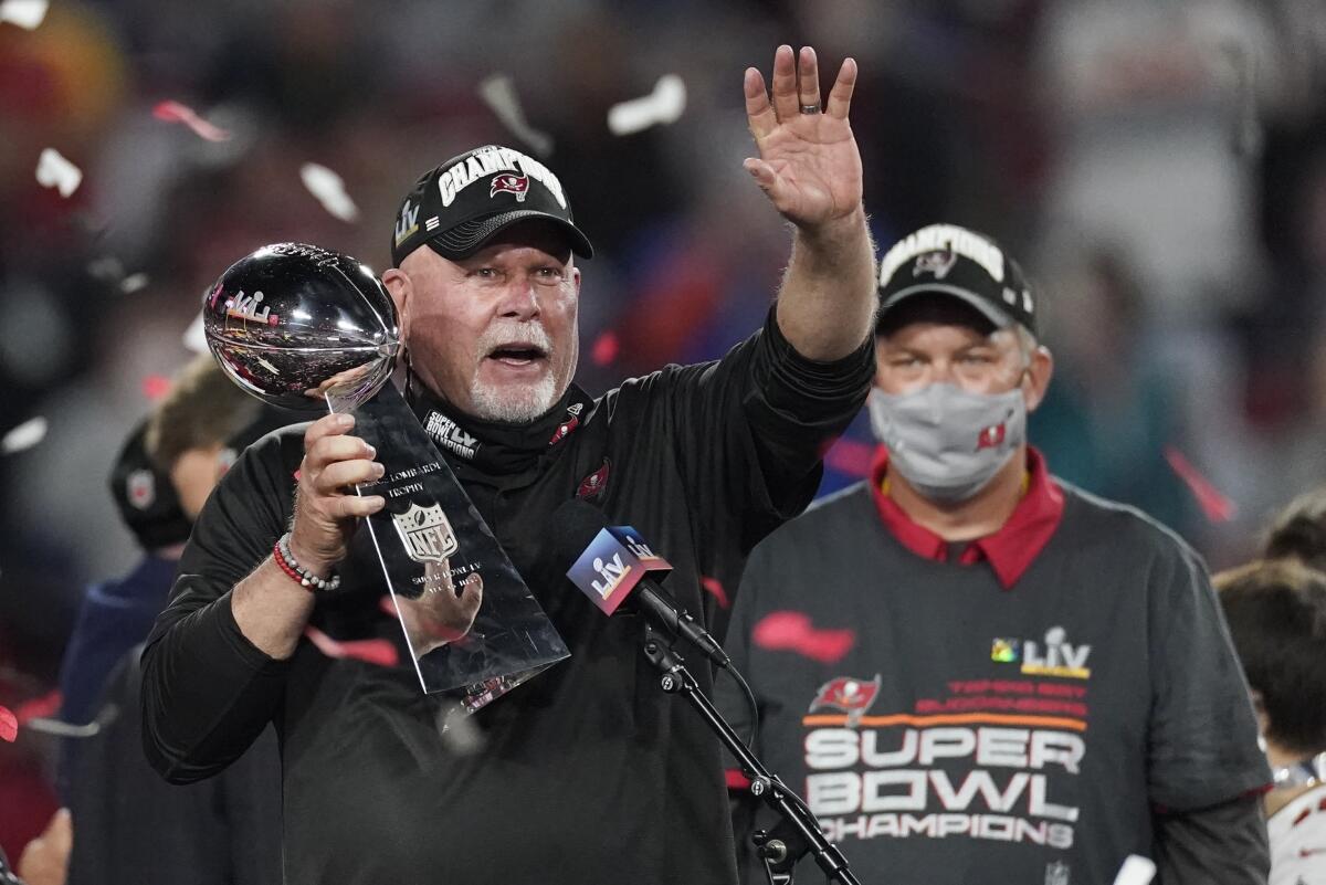Buccaneers head coach Bruce Arians holds up the Vince Lombardi trophy after winning Super Bowl LV.