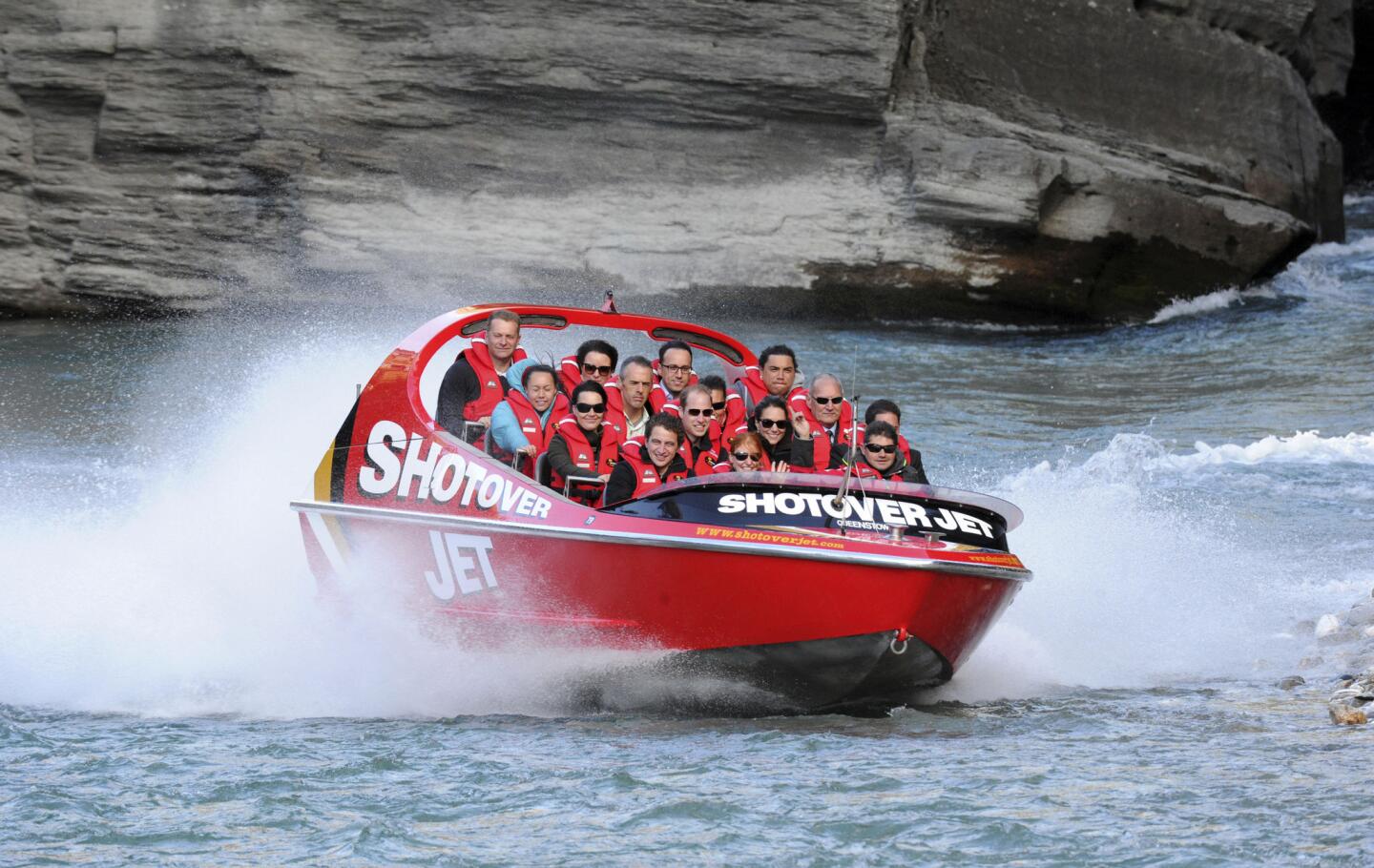 Britain's Prince William, center, and his wife Kate take a ride on a jet boat along the Shotover River in Queenstown, New Zealand, on Sunday.