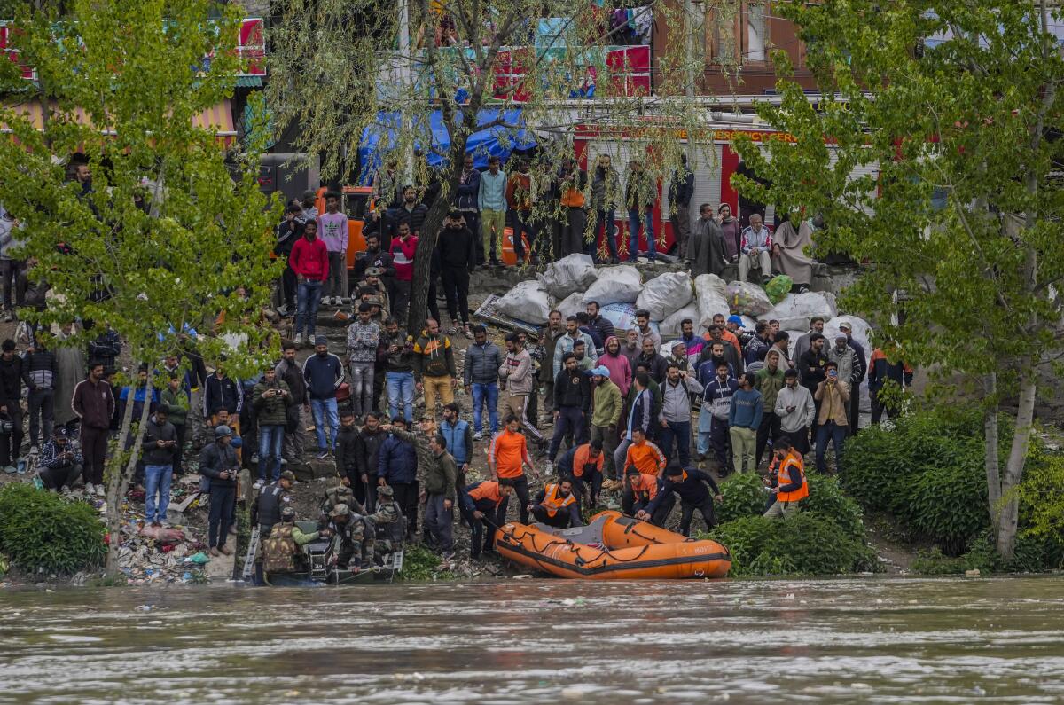 Rescuers prepare to search after a boat carrying people including children capsized in Jhelum river on the outskirts of Srinagar, Indian controlled Kashmir, Tuesday, April. 16, 2024. Rescue operation is continuing for the several missing people. (AP Photo/Mukhtar Khan)