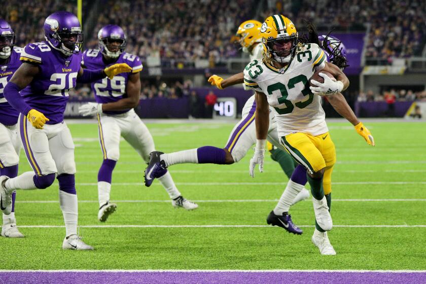 MINNEAPOLIS, MINNESOTA - DECEMBER 23: Running back Aaron Jones #33 of the Green Bay Packers rushes for a touchdown in the third quarter of the game against the Minnesota Vikings at U.S. Bank Stadium on December 23, 2019 in Minneapolis, Minnesota. (Photo by Adam Bettcher/Getty Images)