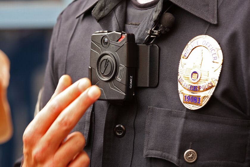 Los Angeles Police Officer Jim Stover demonstrates a new LAPD body camera on Sept. 4, 2015.