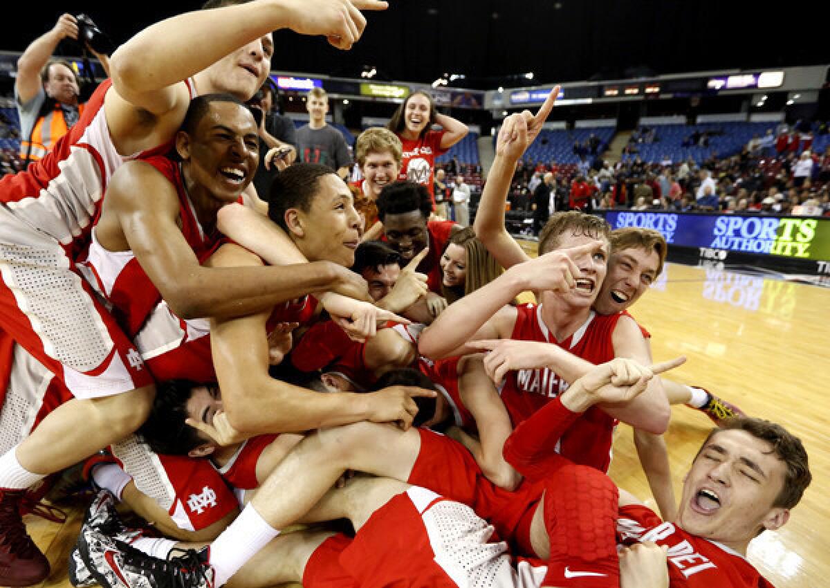 Mater Dei players celebrate after their 71-61 victory over Bishop O' Dowd in the Open Division state championship game.