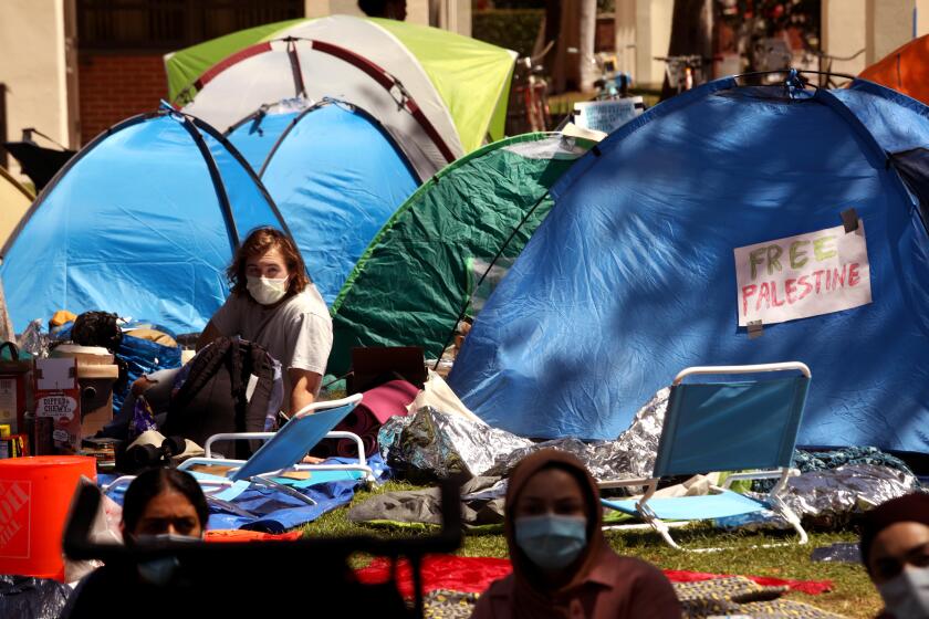 LOS ANGELES, CA - APRIL 27, 2024 - USC students, who protest the war in Gaza, spend time at the tent camp they erected at Founders Park on the USC campus in Los Angeles on April 27, 2024. The campus gates are closed to the public and the marquee 65,000-attendee "main stage" commencement ceremony has been called off. (Genaro Molina/Los Angeles Times)