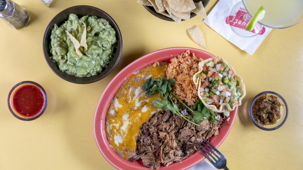 The carnitas plate, with a side of guacamole and chips, salsas, and a margarita at El Coyote in Hollywood.