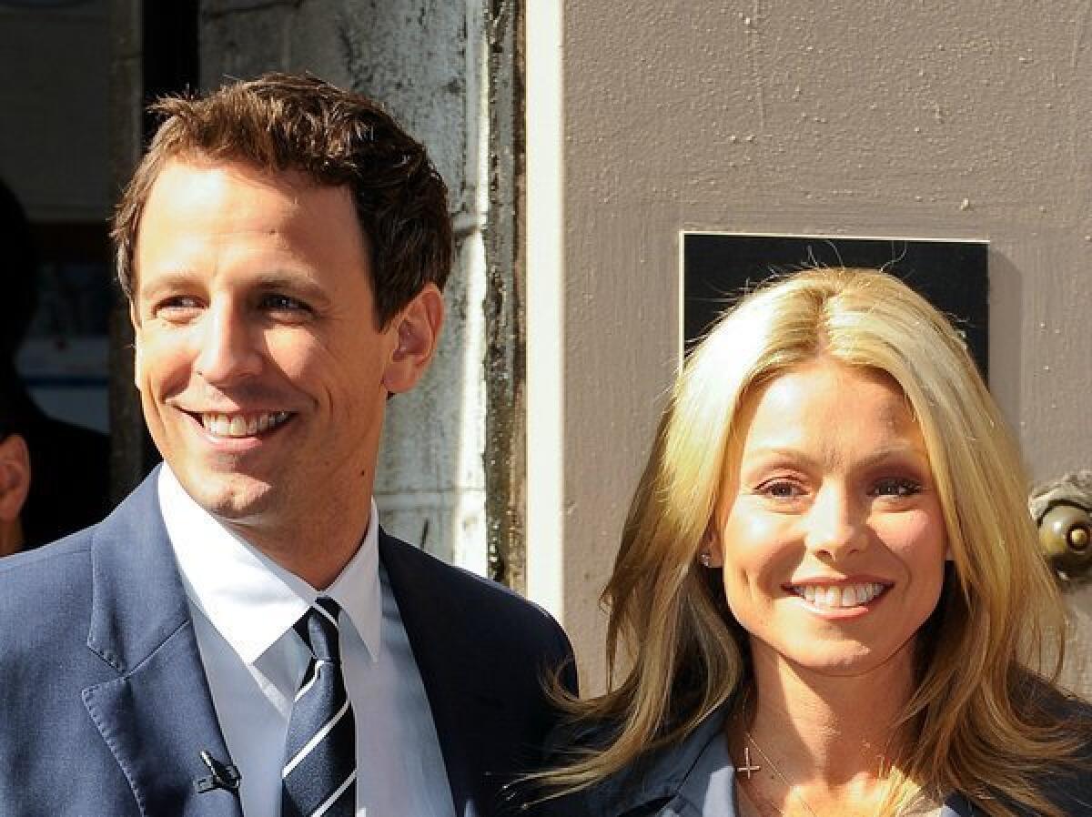 Actor Seth Meyers, left, and TV personality Kelly Ripa tape a segment for "Live! With Regis And Kelly" at the ABC Lincoln Center Studios on April 18, 2011, in New York City