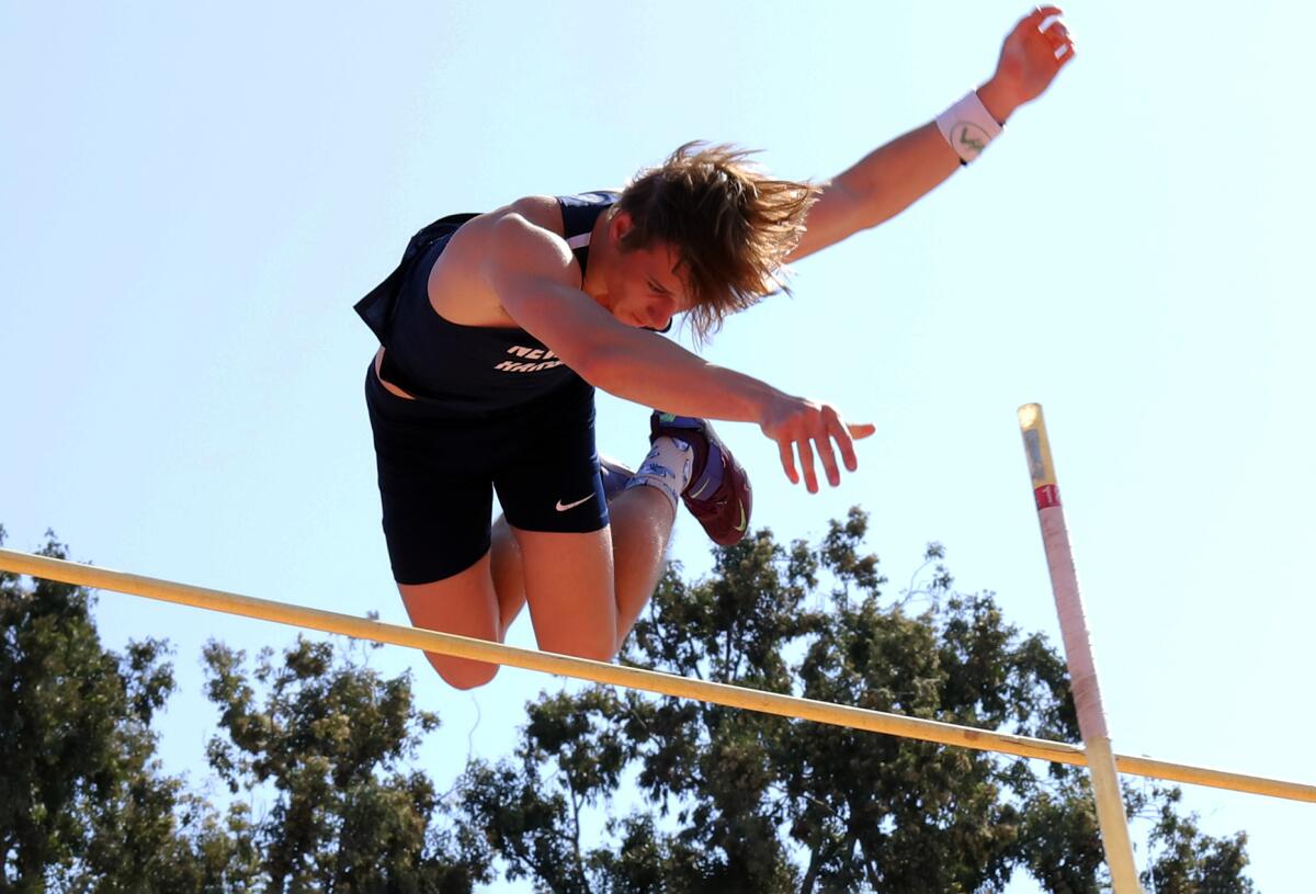 Newport Harbor's Leo Davis clears the bar at 14 feet, 1 inch in the pole vault on Saturday.