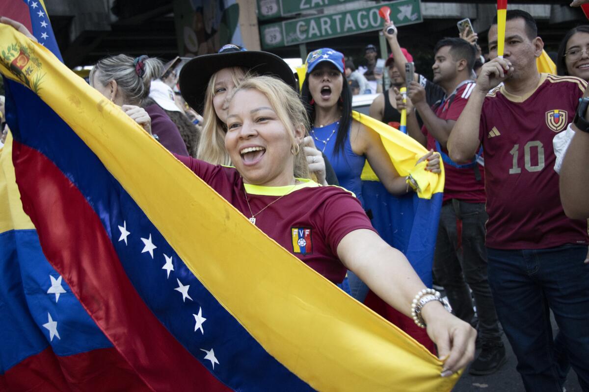 Venezuelan citizens with flags in Costa Rica celebrate during a rally