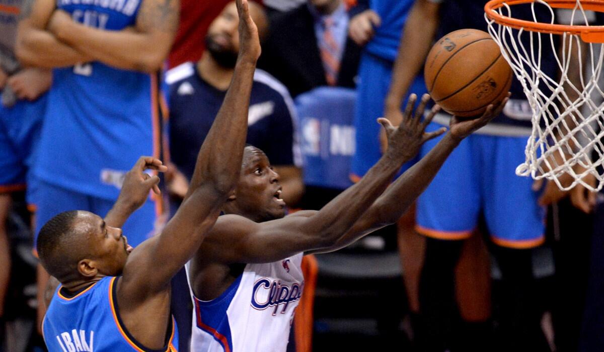 Clippers guard Darren Collison beats Thunder power forward Serge Ibaka down the lane for a layup in Game 4 of their playoff series on Sunday at Staples Center.