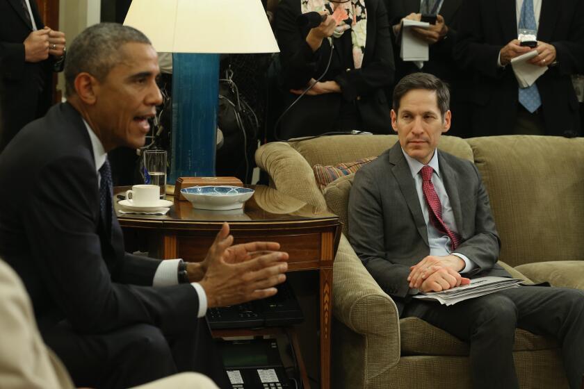 President Obama, alongside the CDC's Tom Frieden, speaks to the media about the fight against the Ebola virus during a meeting with his Ebola Response Team in the Oval Office.