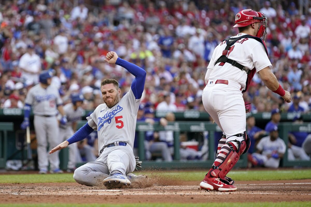 Dodgers baserunner Freddie Freeman scores past St. Louis Cardinals catcher Andrew Knizner during the fourth inning Thursday.