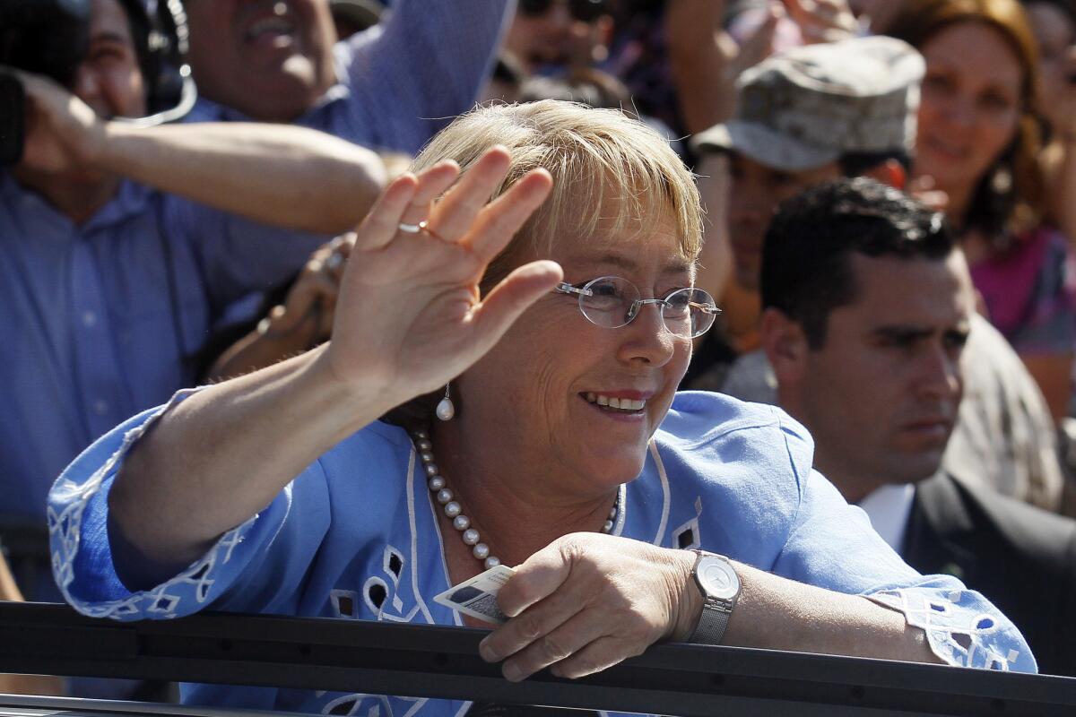 Chile's former President Michelle Bachelet waves to supporters after casting her vote during presidential elections Sunday in Santiago, the capital.