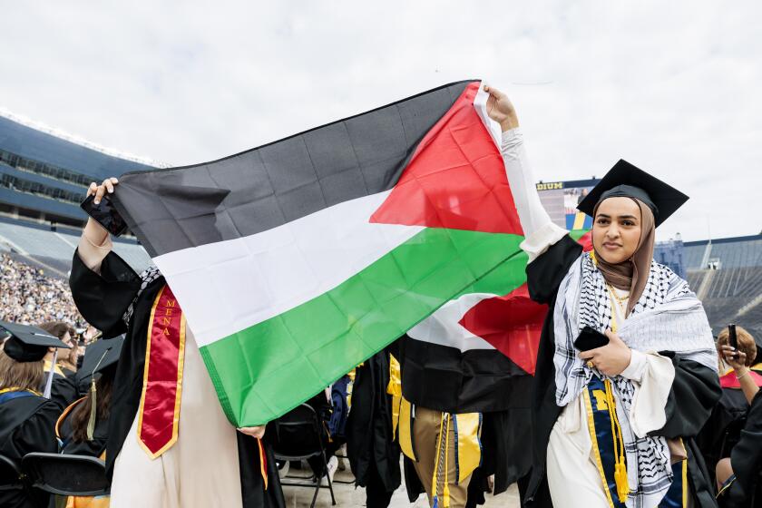 Pro-Palestinian protesters demonstrate during the University of Michigan's Spring 2024 Commencement Ceremony at Michigan Stadium in Ann Arbor, Mich., on Saturday, May 4, 2024.( Jacob Hamilton/Ann Arbor News via AP)