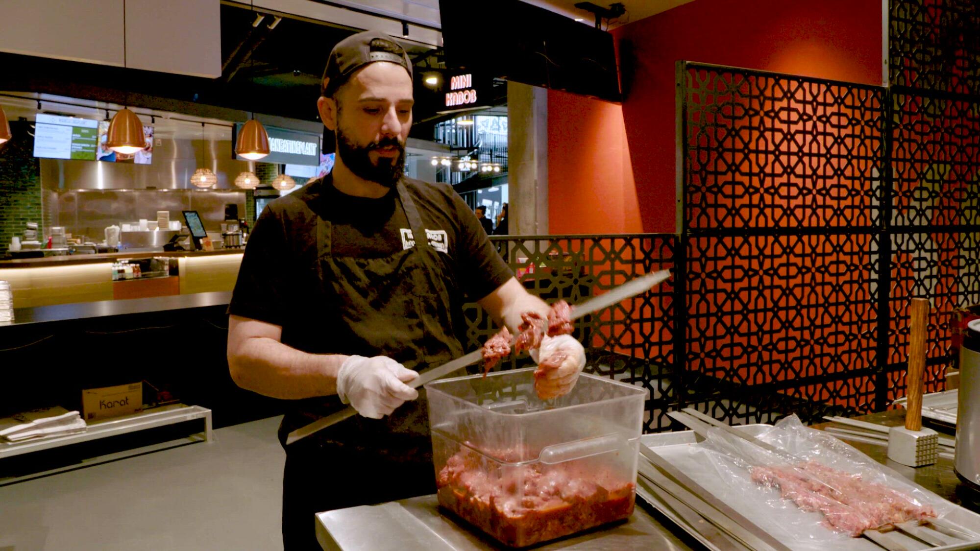 Armen Martirosyan skewers meat at the new location of his family's restaurant Mini Kabob at Topanga Social.