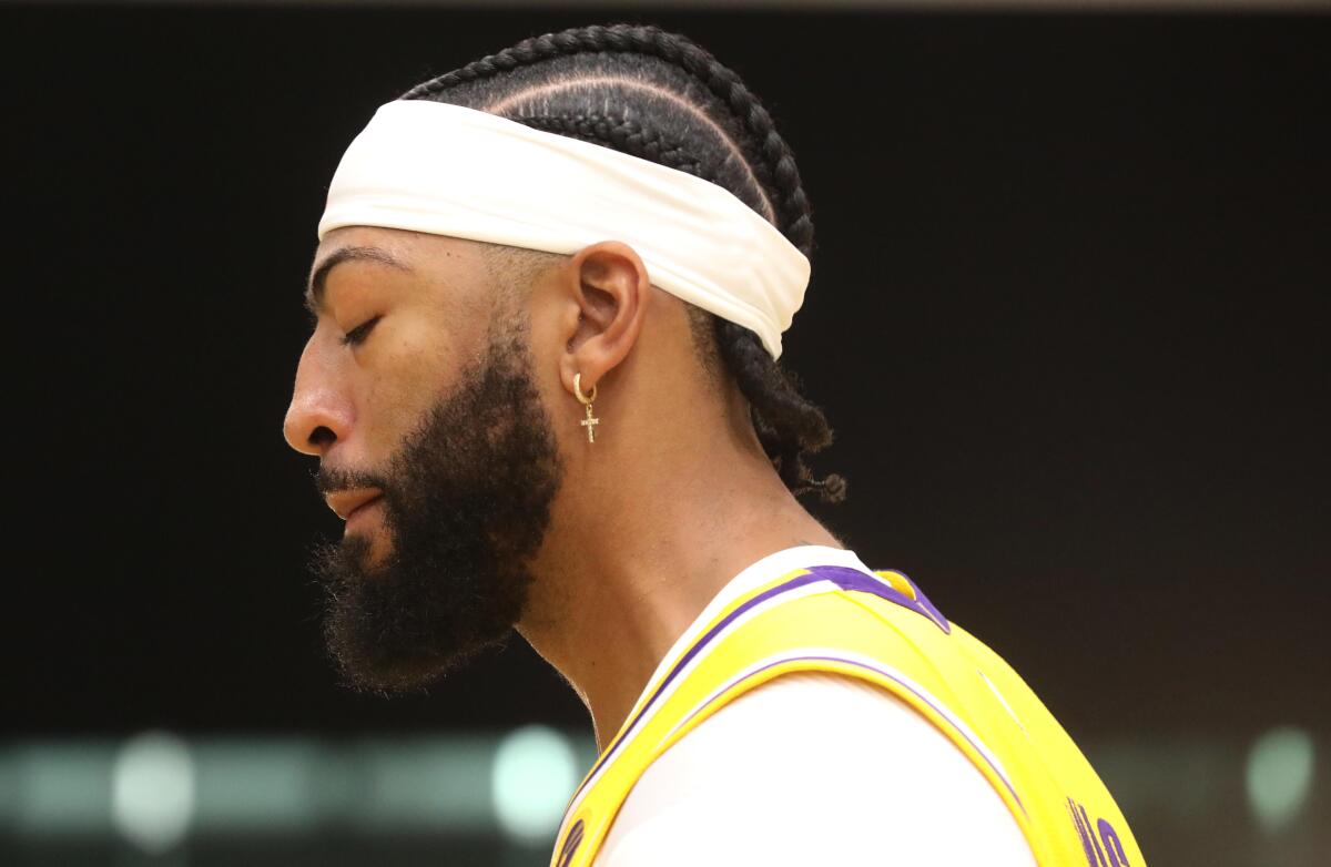 Lakers star Anthony Davis closes his eyes as he's lost in thought during media day.