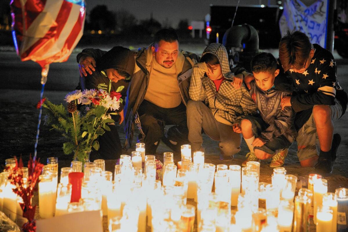 Ivan Ibarra, left, Freddy Ibarra, Bryan Alcaraz, Emmanuel Acosta and Julian Herrera kneel in prayer for the victims of the shooting rampage in San Bernardino.