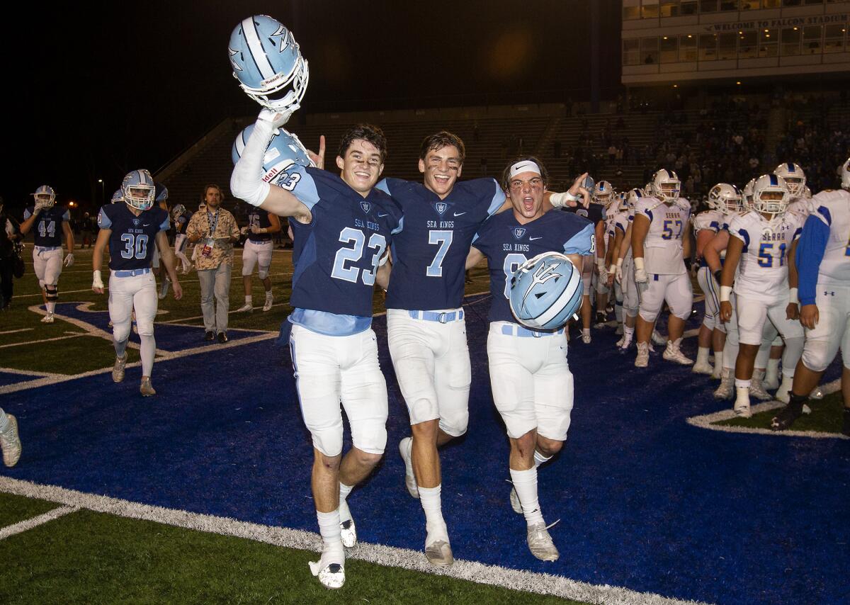 From left, Corona del Mar's Zack Green, Mason Gecowets and Ryder Haupt are all smiles after the Sea Kings defeat San Mateo Serra 35-27 in the CIF State Division 1-A title game at Cerritos College on Dec. 14.
