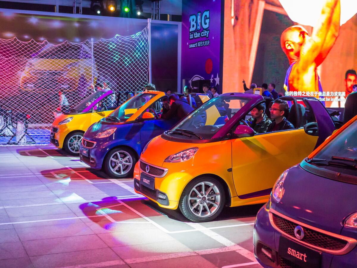 Smart Cars on display outside the arena before the Lakers' exhibition game Tuesday in Beijing. Bryant appears in commercials for the cars on Chinese TV.