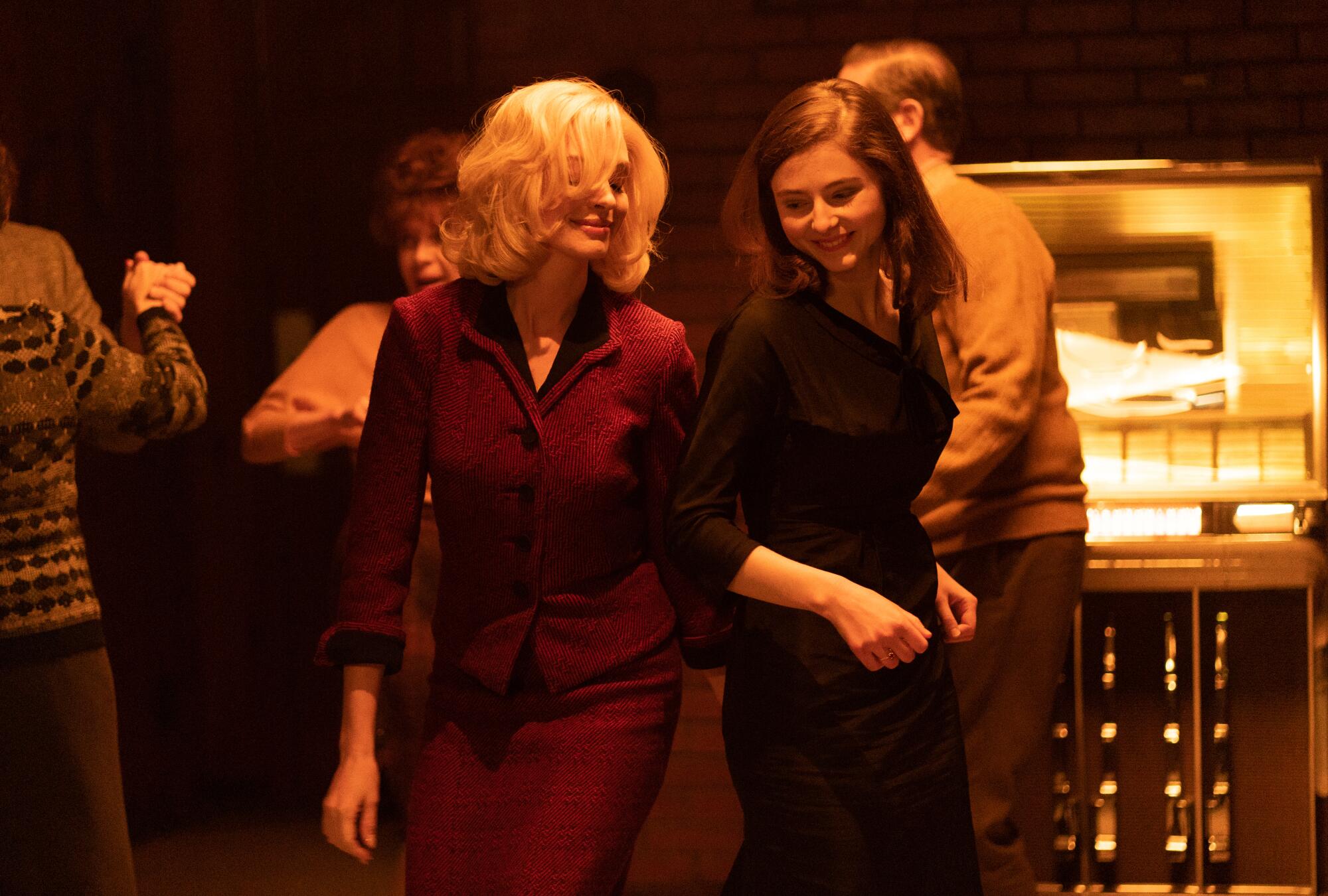 Anne Hathaway and Thomasin McKenzie as Rebecca and Eileen in the film "Eileen."