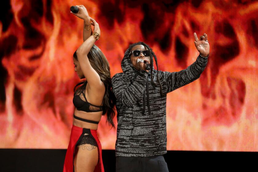 Christina Milian and Lil Wayne perform at the American Music Awards at the Nokia Theatre on Nov. 23.