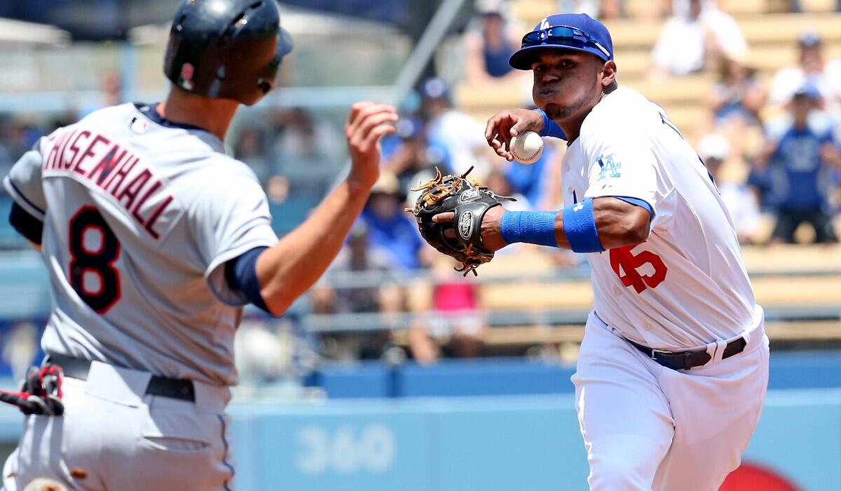 Dodgers shortstop Carlos Triunfel loses control of the ball when transferring it to his throwing hand after forcing out Cleveland's Lonnie Chisenhall on Wednesday afternoon.