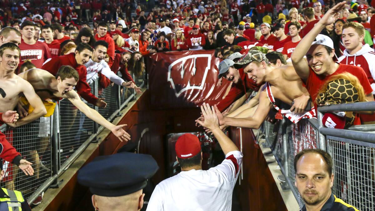 Wisconsin Coach Paul Chryst is greeted by fans after Wisconsin beat Nebraska.