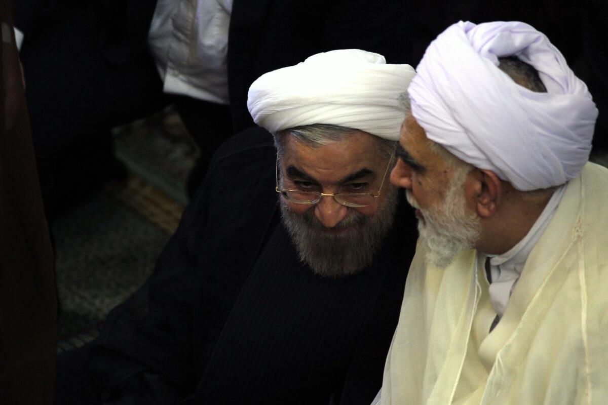 Iranian President-elect Hassan Rouhani, left, attends Friday prayers last week.