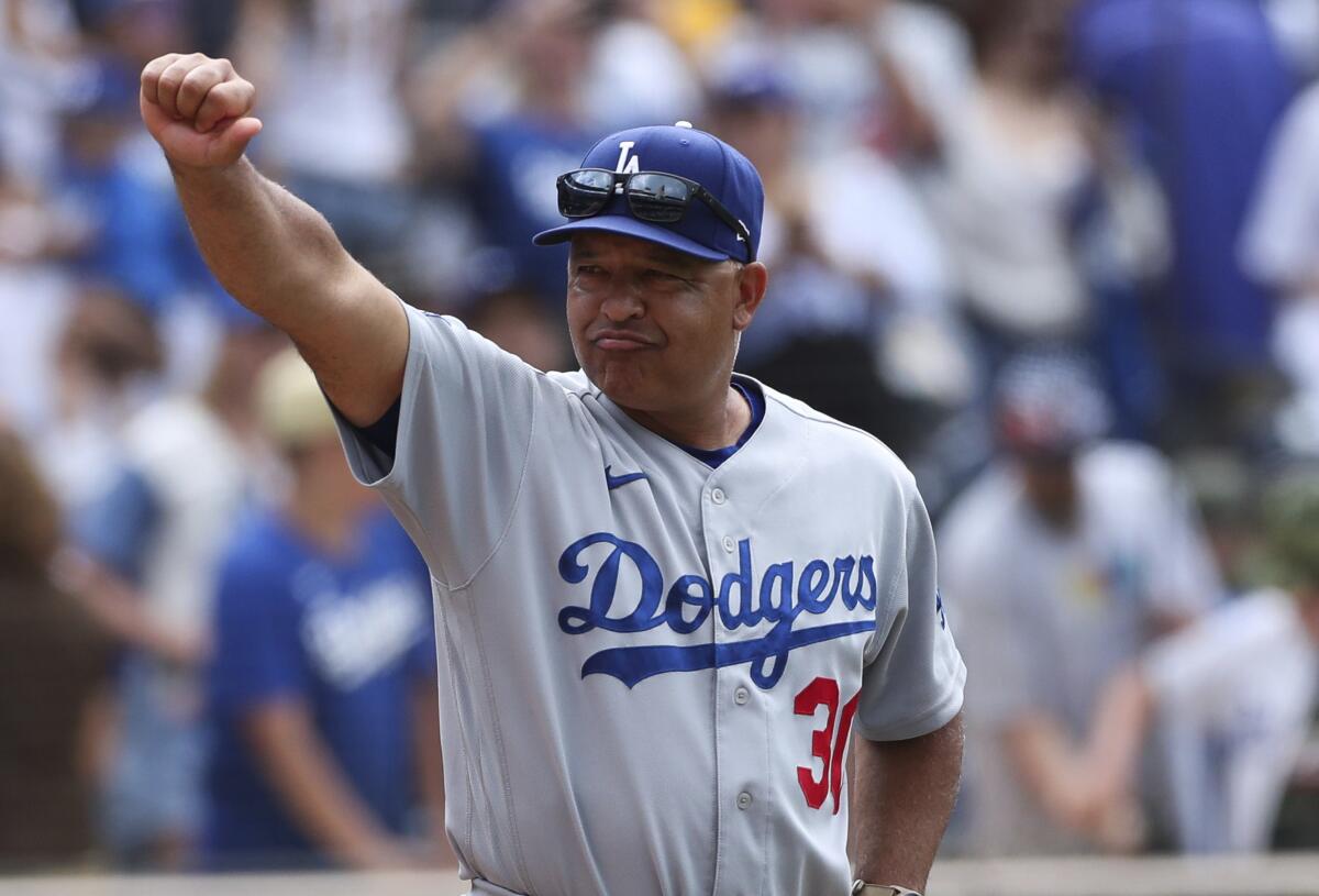 Dodgers manager Dave Roberts gestures to the crowd after an 11-2 victory over the San Diego Padres.