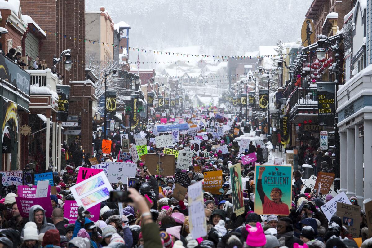 People march down Main Street on Saturday in Park City, Utah, during the March on Main event during the Sundance Film Festival.