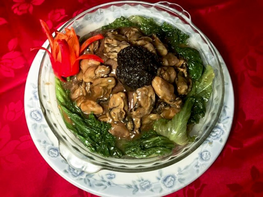 A photo of Hop Woo BBQ & Seafood Restaurant's braised dried oysters and lettuce topped with fat choy.